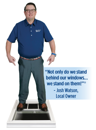 Window World owners standing on a window beside the message: Not only do we stand behind our windows, we stand on them. Locally Owned and Operated.